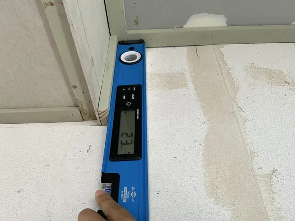 Level check at doorway — defect found during enclosed/waterproofing inspection in Brisbane