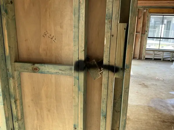 Bracing strap at wall junction